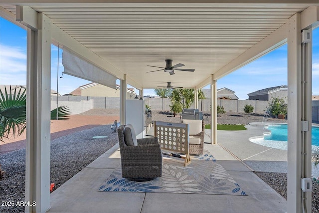 view of patio featuring area for grilling, a fenced in pool, a fenced backyard, and ceiling fan