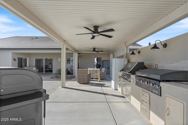 view of patio / terrace featuring area for grilling and ceiling fan