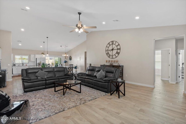 living room featuring recessed lighting, baseboards, lofted ceiling, and light wood-style floors