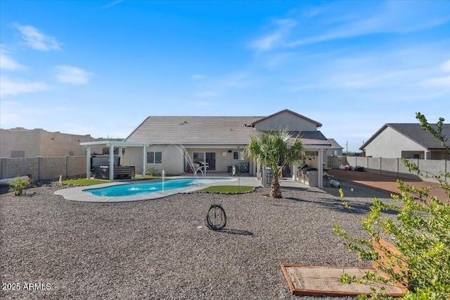 rear view of house featuring a patio area, a fenced in pool, and a fenced backyard