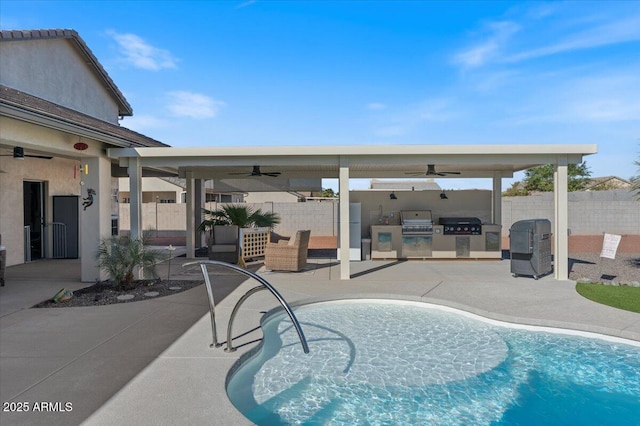 view of pool with a patio, a ceiling fan, fence, exterior kitchen, and area for grilling