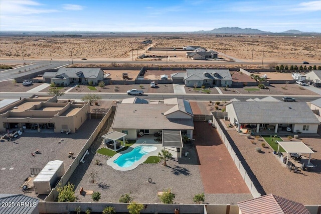 birds eye view of property featuring a mountain view, a residential view, and a desert view