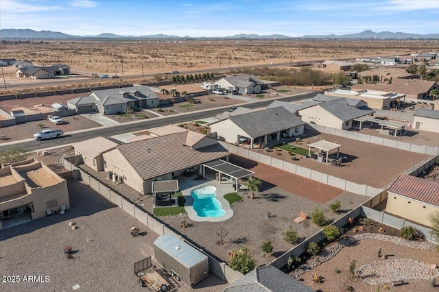 aerial view featuring a mountain view, a residential view, and a desert view