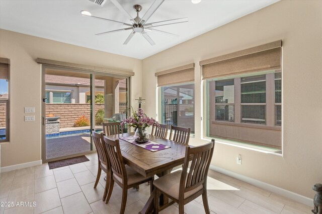 644 E Las Puertas Ln, Queen Creek, AZ 85140 - dining space with light tile patterned floors, baseboards, and a ceiling fan