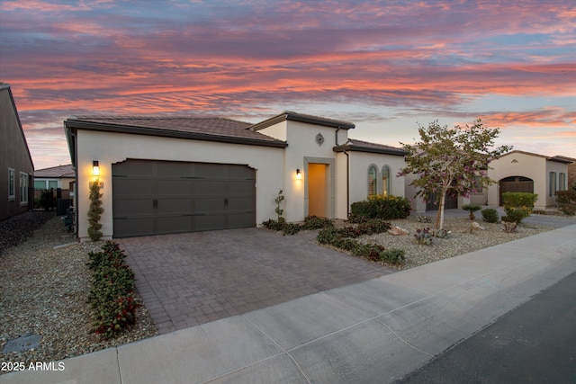 644 E Las Puertas Ln, Queen Creek, AZ 85140 - view of front of property with a garage, stucco siding, and decorative driveway