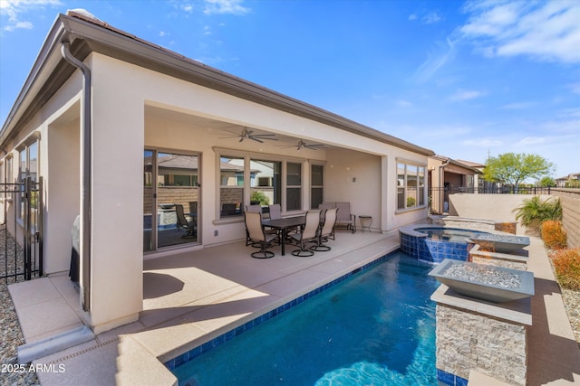 644 E Las Puertas Ln, Queen Creek, AZ 85140 - rear view of house featuring stucco siding, a patio area, ceiling fan, a pool with connected hot tub, and fence