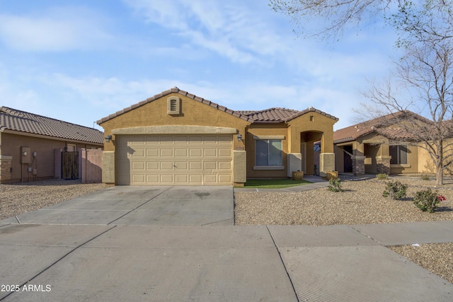 mediterranean / spanish-style home featuring stucco siding, a garage, driveway, and a tiled roof