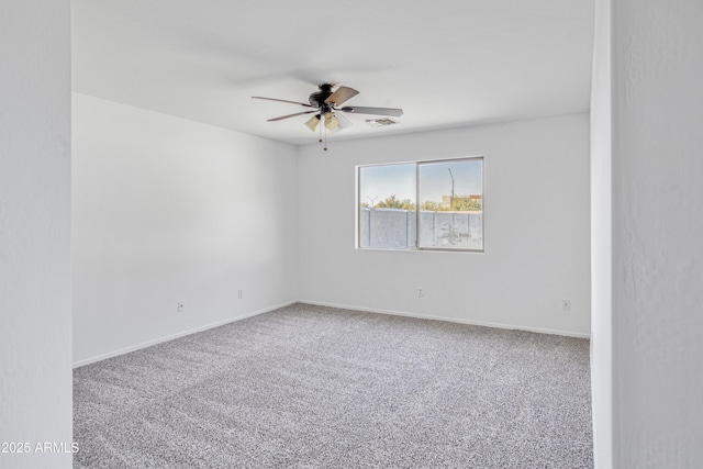 empty room featuring visible vents, baseboards, ceiling fan, and carpet floors