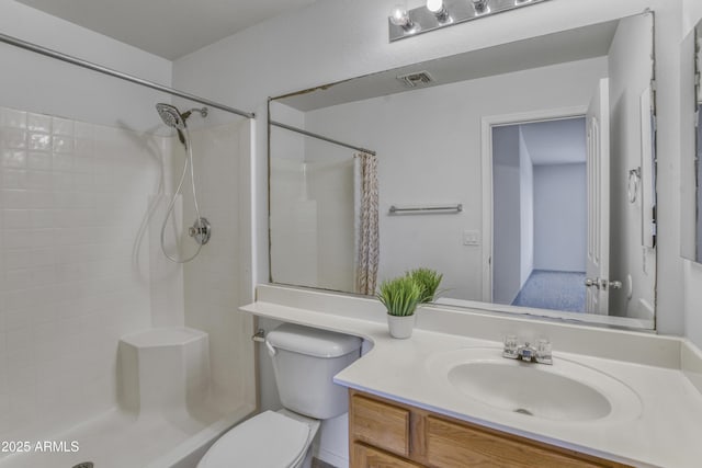 bathroom with vanity, a shower with shower curtain, toilet, and visible vents