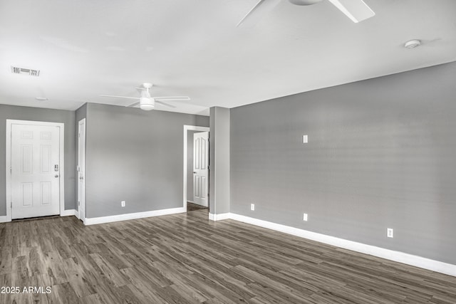 interior space featuring wood finished floors, a ceiling fan, baseboards, and visible vents