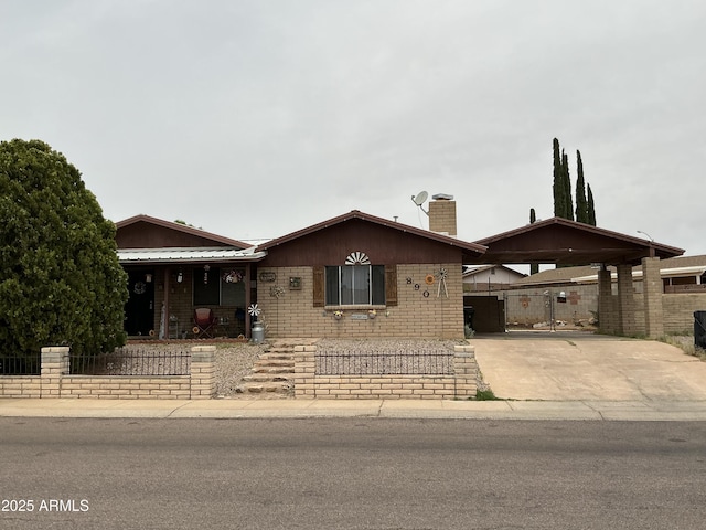890 Palo Verde Dr, Sierra Vista, AZ 85635 - view of front of property with a chimney, concrete driveway, a porch, brick siding, and an attached carport