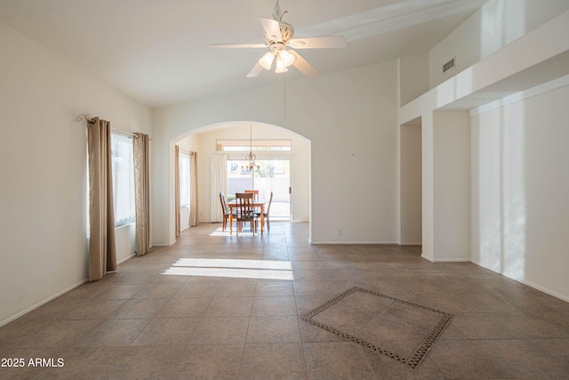 empty room featuring a healthy amount of sunlight, light tile patterned floors, and ceiling fan