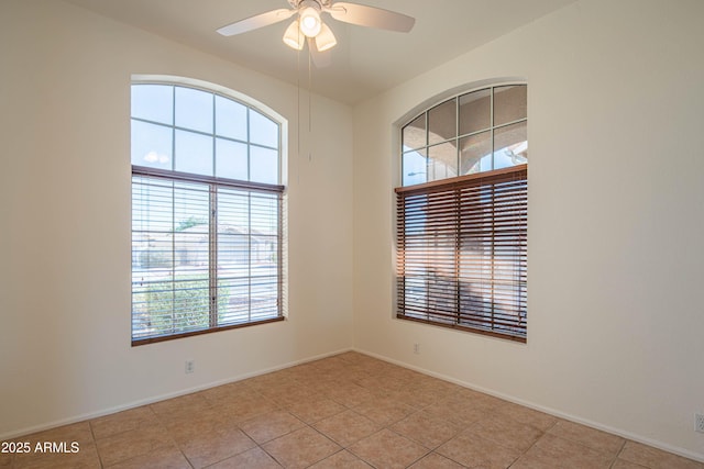 spare room featuring light tile patterned floors and ceiling fan