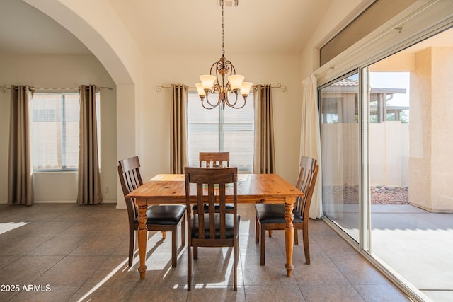 tiled dining room featuring a notable chandelier