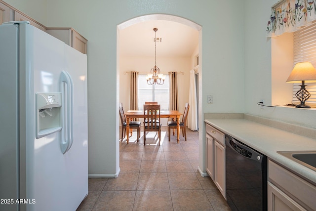 kitchen with decorative light fixtures, a chandelier, light tile patterned floors, dishwasher, and white fridge with ice dispenser