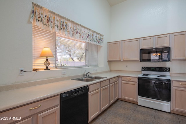 kitchen featuring light tile patterned flooring, sink, light brown cabinets, and black appliances