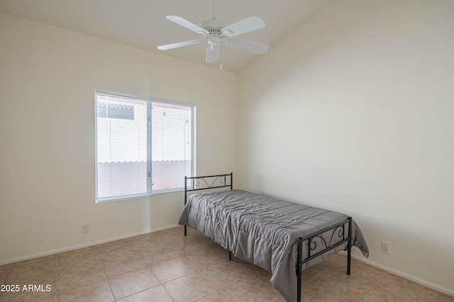 tiled bedroom featuring ceiling fan