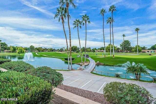 view of property's community featuring a yard and a water view