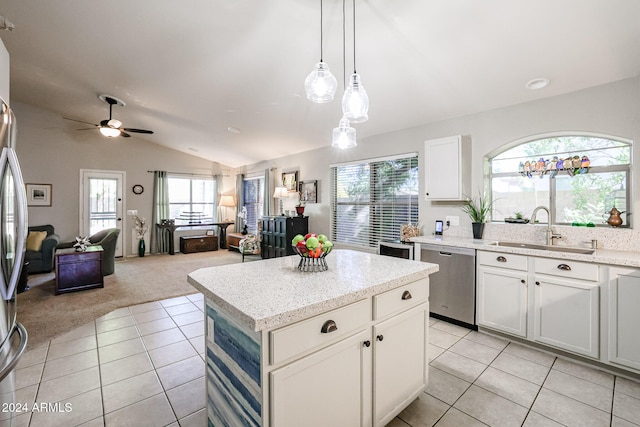 kitchen featuring sink, a kitchen island, white cabinets, light colored carpet, and dishwasher