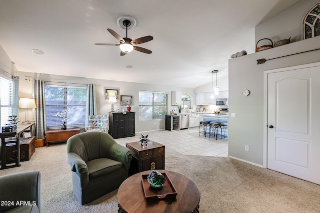 living room featuring light carpet, ceiling fan, and vaulted ceiling