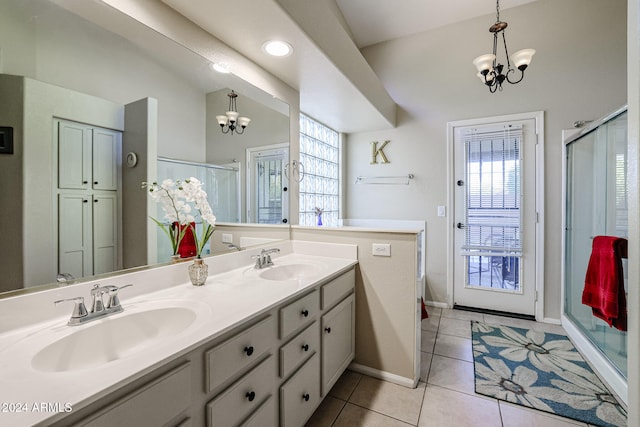 bathroom featuring walk in shower, vanity, an inviting chandelier, and tile patterned flooring