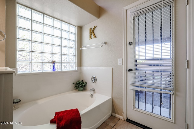 bathroom with a bath and tile patterned floors