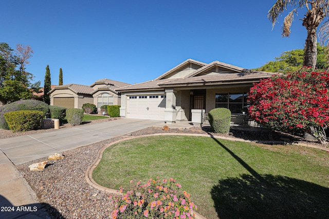 view of front of property with a garage and a front yard