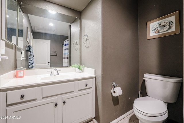 bathroom featuring curtained shower, vanity, tile patterned floors, and toilet