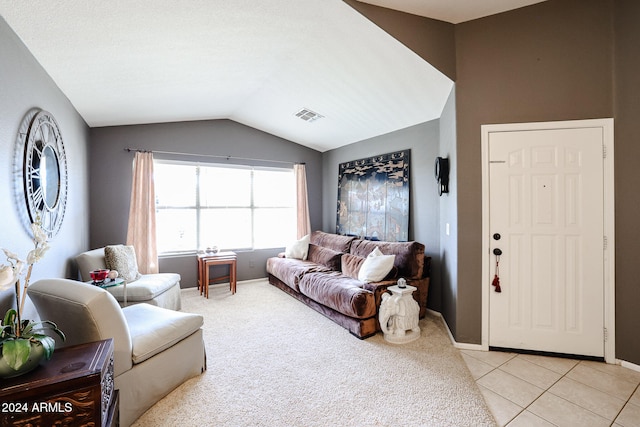 living room with lofted ceiling and light tile patterned floors