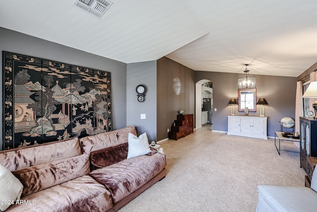 carpeted living room with a notable chandelier