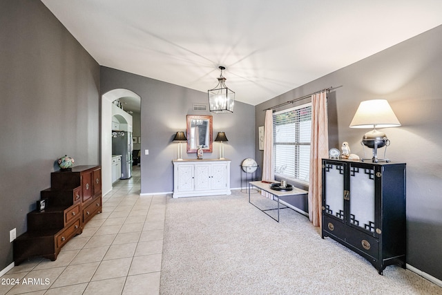 sitting room featuring light tile patterned floors and a notable chandelier