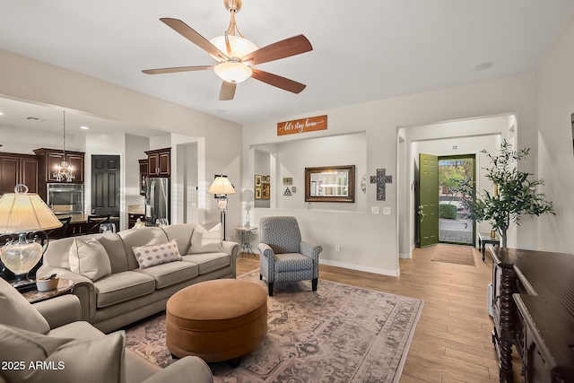27276 N 81st Ln, Peoria, AZ 85383 - living room with light wood finished floors, ceiling fan, and baseboards