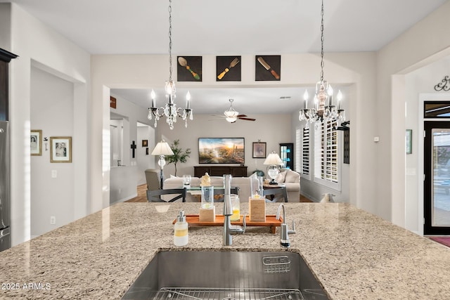 27276 N 81st Ln, Peoria, AZ 85383 - kitchen with a chandelier, light stone counters, a ceiling fan, and plenty of natural light