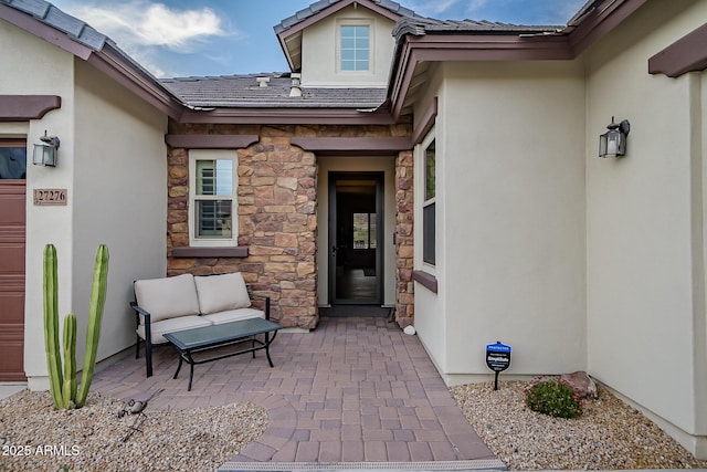 27276 N 81st Ln, Peoria, AZ 85383 - view of exterior entry featuring stone siding, stucco siding, and a patio