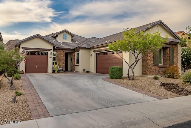 27276 N 81st Ln, Peoria, AZ 85383 - view of front of home with stone siding, a garage, driveway, and stucco siding