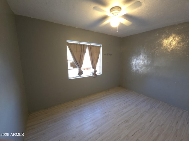 spare room featuring ceiling fan and light hardwood / wood-style floors