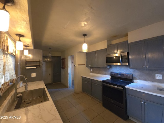 kitchen with pendant lighting, backsplash, black electric range oven, and sink