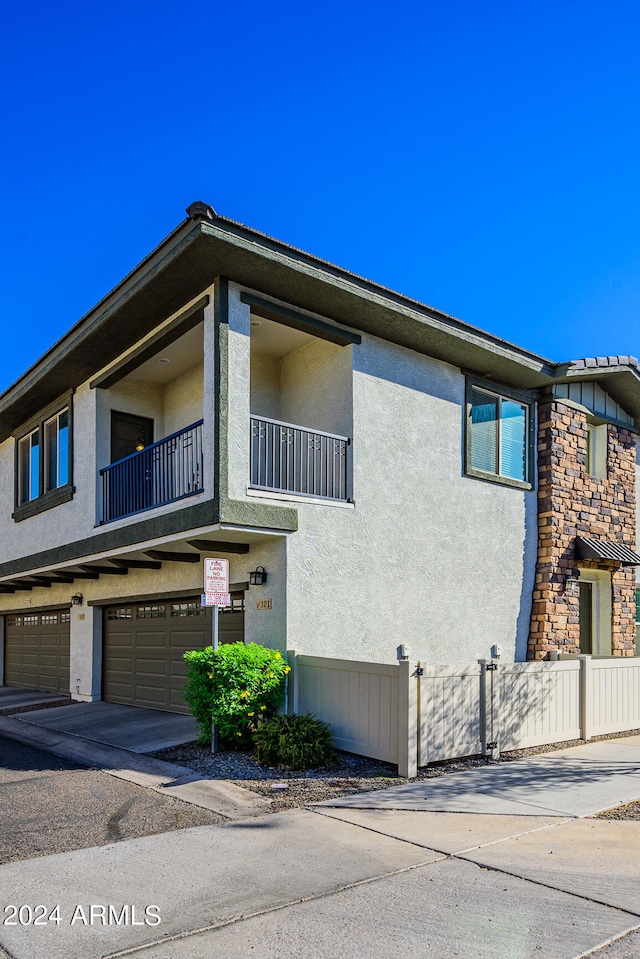 view of front facade with a garage and a balcony