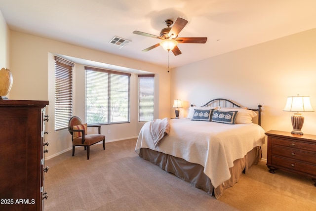 bedroom featuring ceiling fan, light colored carpet, visible vents, and baseboards