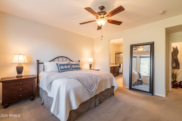 bedroom featuring baseboards, light colored carpet, ceiling fan, and ensuite bathroom