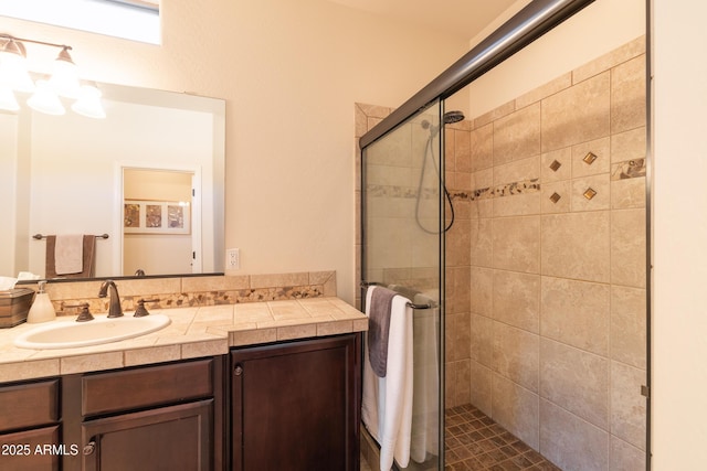 bathroom featuring a stall shower and vanity