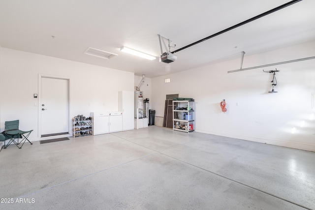 garage featuring water heater and a garage door opener