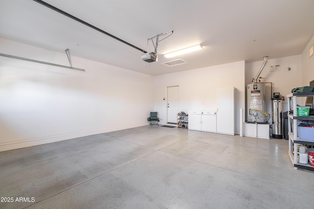 garage with gas water heater and a garage door opener