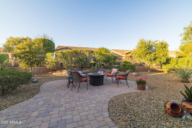 view of patio / terrace featuring a fire pit and a fenced backyard