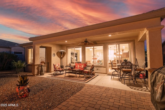 view of patio featuring an outdoor living space and ceiling fan