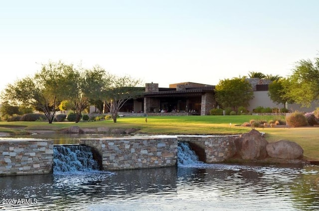 exterior space with a yard and a water view