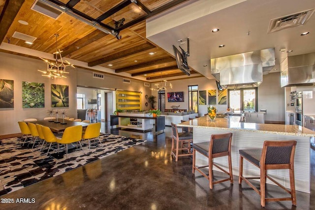 kitchen featuring a chandelier, visible vents, wooden ceiling, and light stone countertops