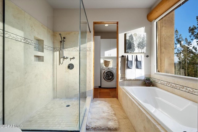 bathroom featuring tile patterned flooring, washer / dryer, and separate shower and tub