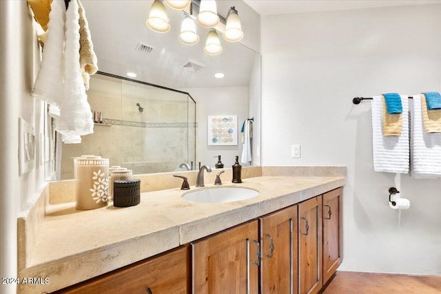 bathroom featuring vanity and a shower with shower door