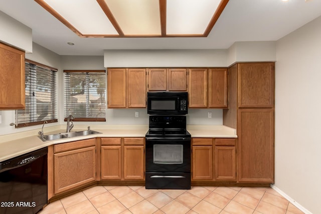 9002 W Caribbean Ln, Peoria, AZ 85381 - kitchen with black appliances, a sink, light countertops, brown cabinets, and light tile patterned floors